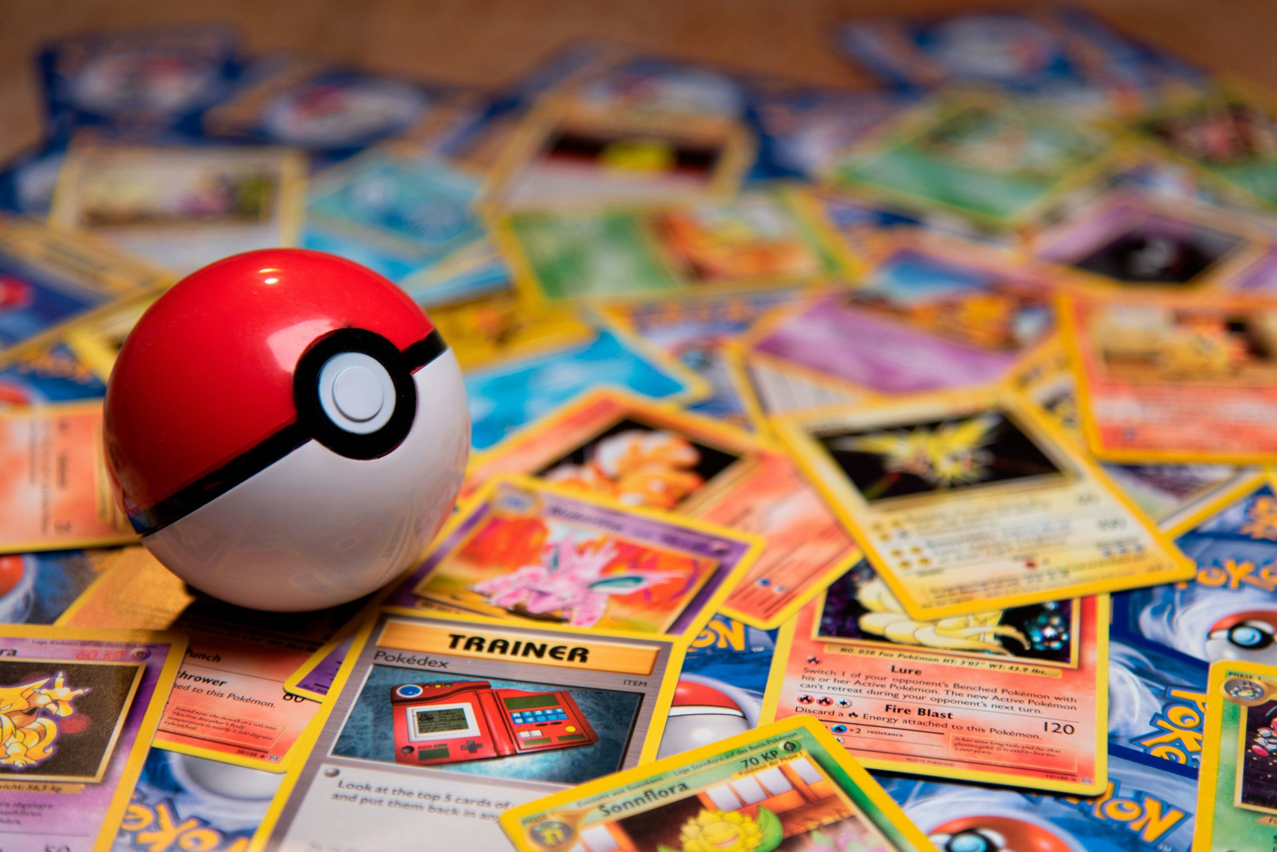 Classic Pokeball toy on a bunch of Pokemon cards