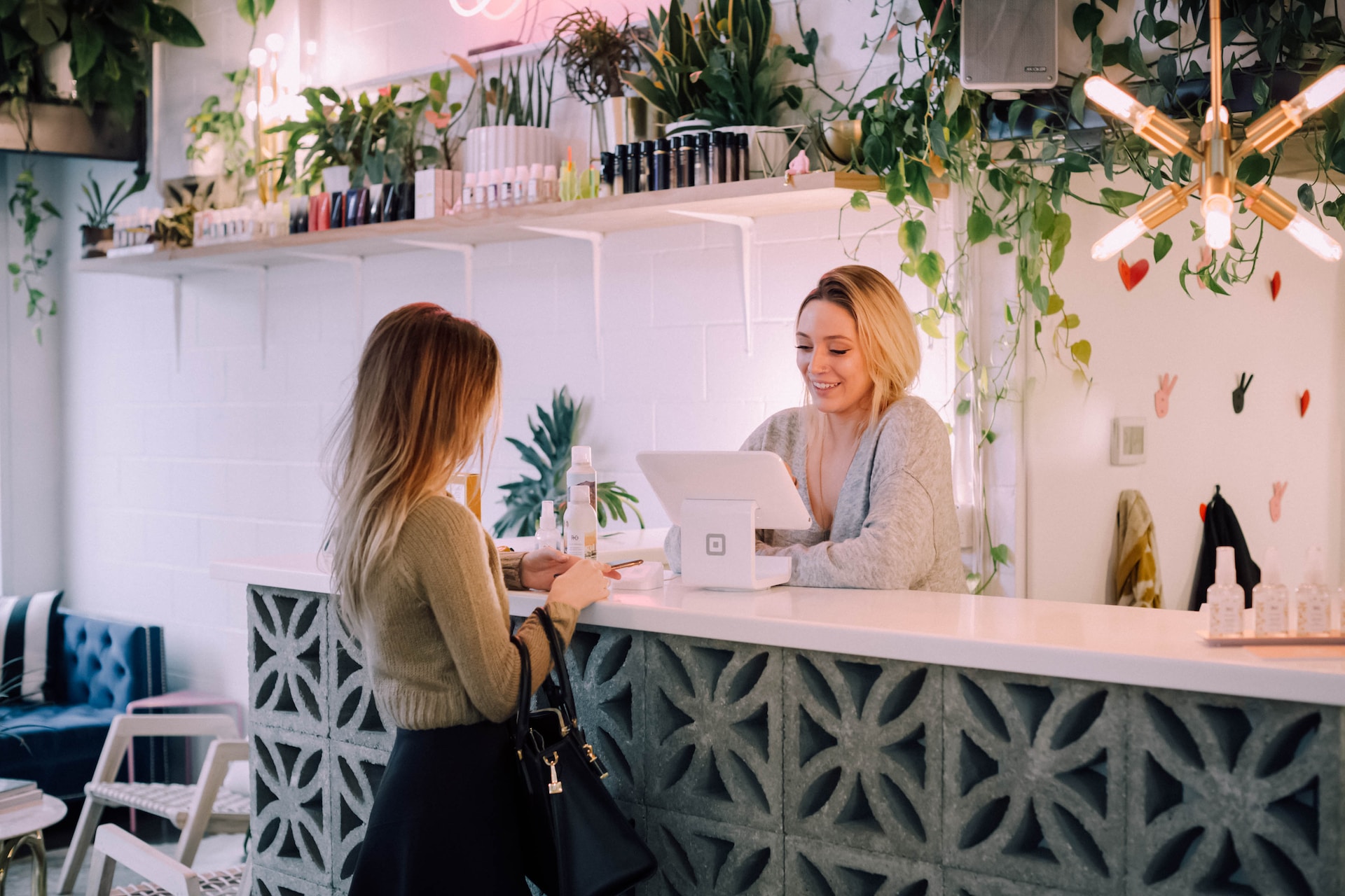A woman interacting with a customer at a kiosk