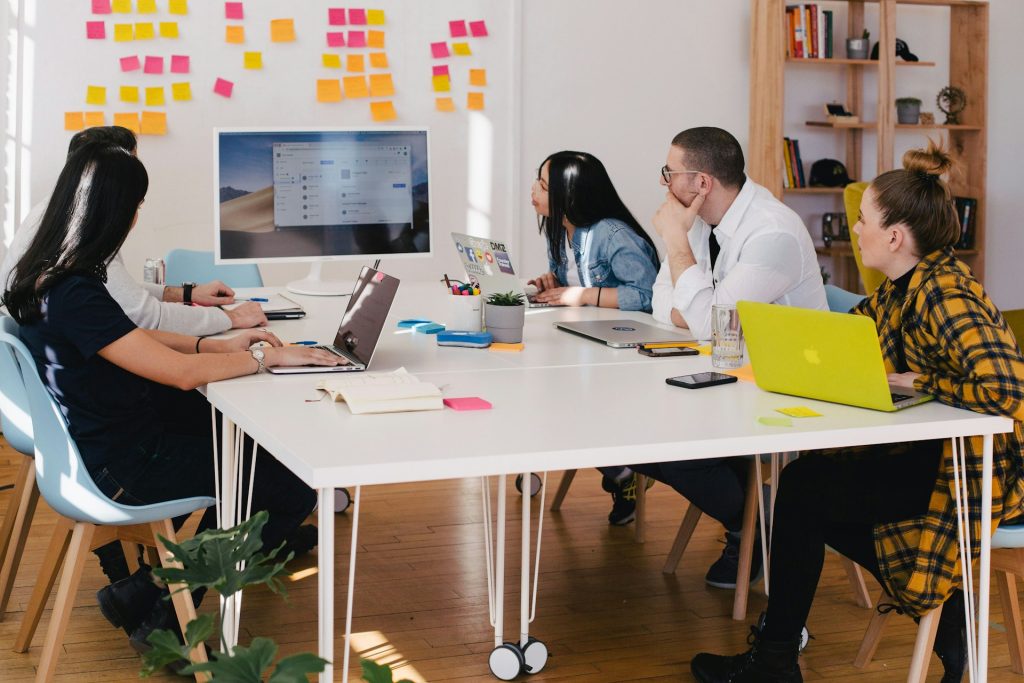 Persons sitting at a table and collaborating on a project