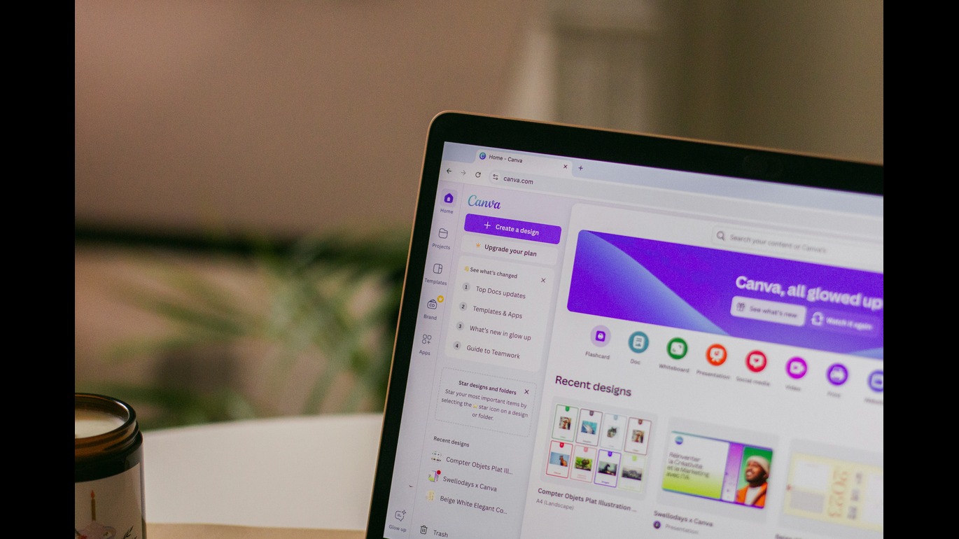 A laptop with Canva on the screen