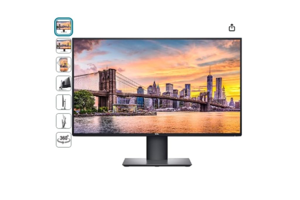 A Dell monitor with an image displaying a city at dusk.