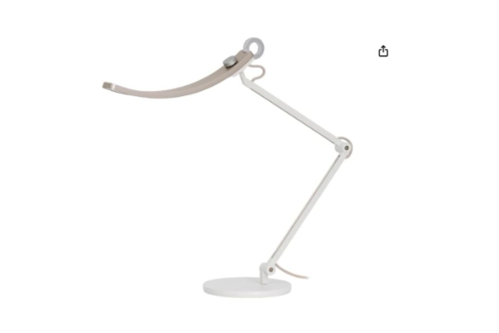 A light gold desk lamp with a curved overhead.