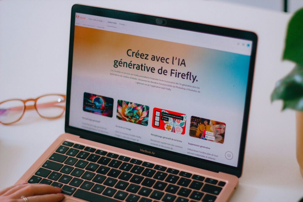 a laptop displaying the homepage of Adobe Firefly