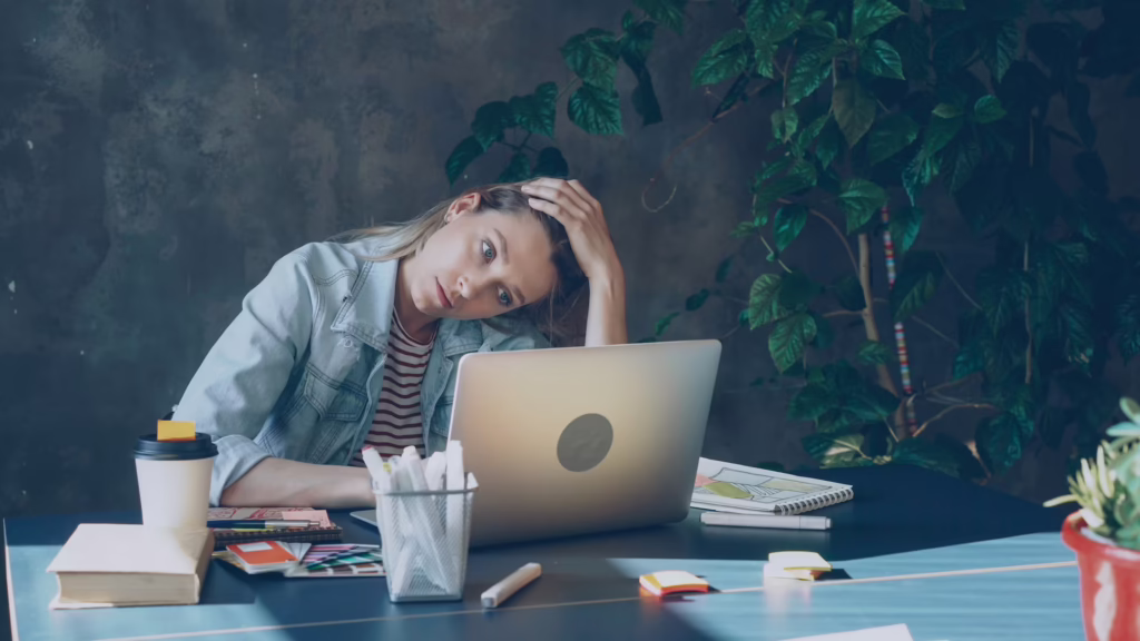 Woman putting hand on forehead, seemingly stressed