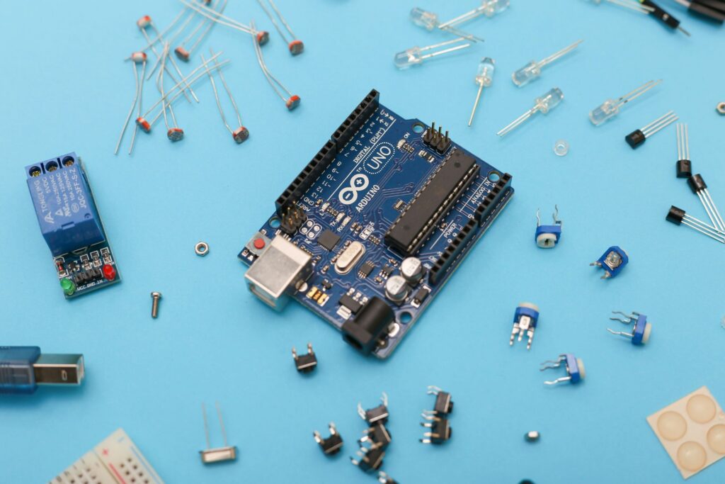 Arduino Uno board surrounded by electronic components