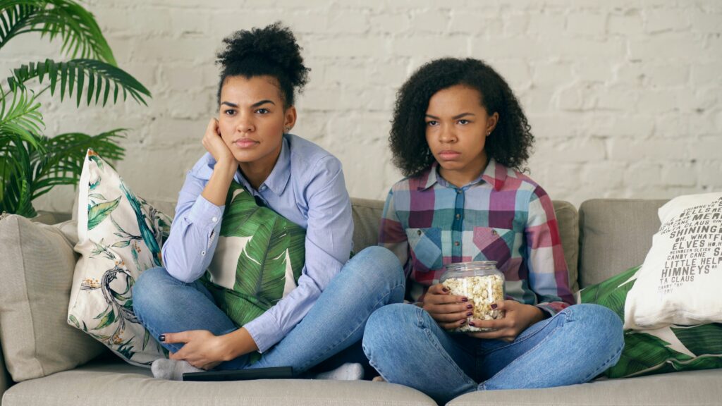 Family watching something.

Image link: https://unsplash.com/photos/two-women-sitting-on-a-couch-with-popcorn-NH75w1R5-7Q