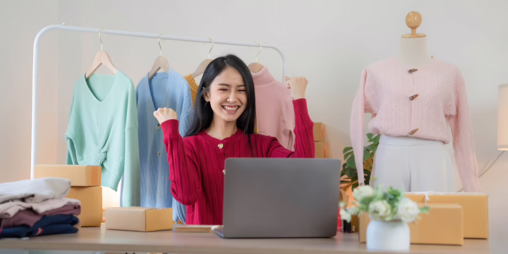 Woman happy with laptop in front of her