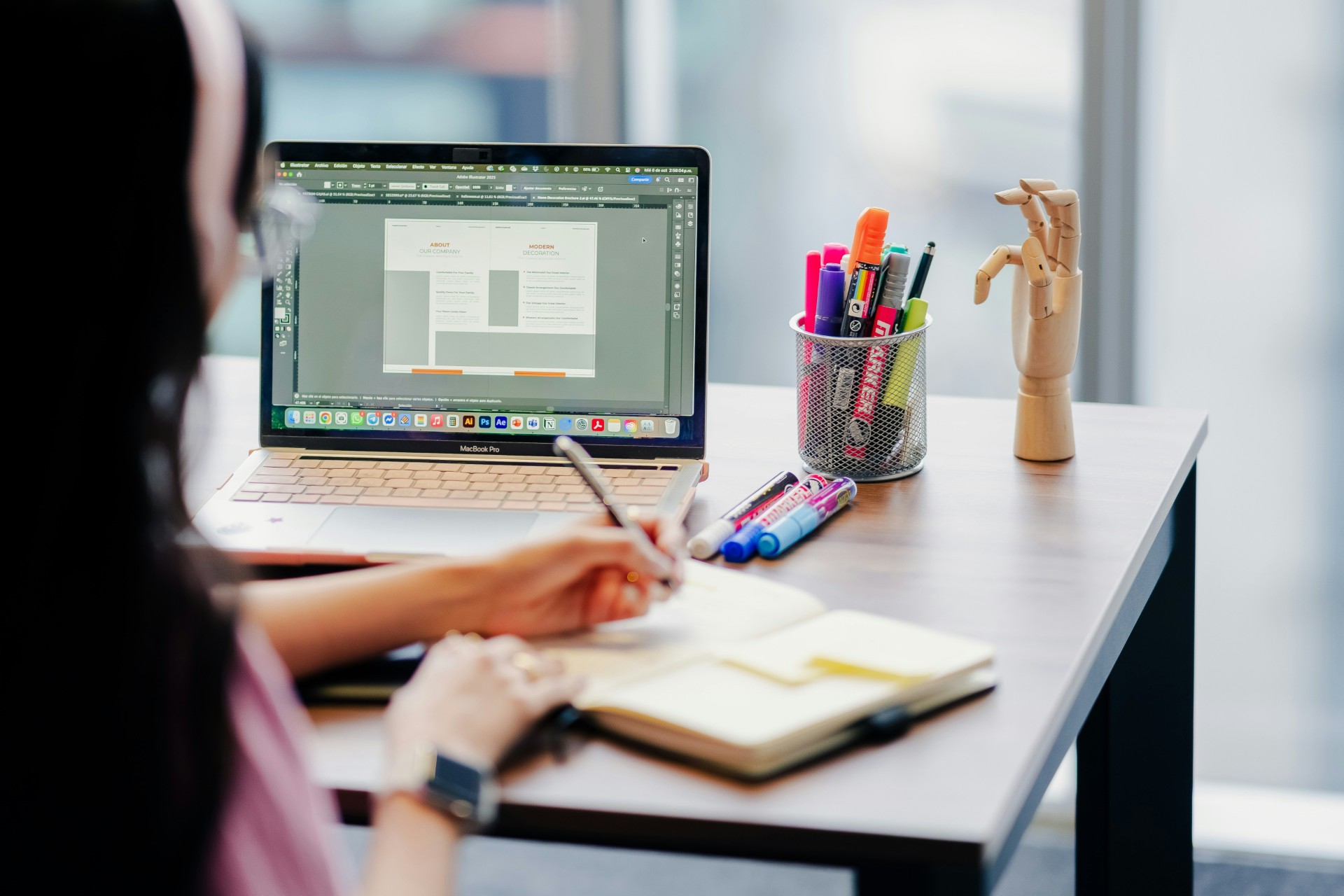 Female designer working on a laptop using AI web design tools.