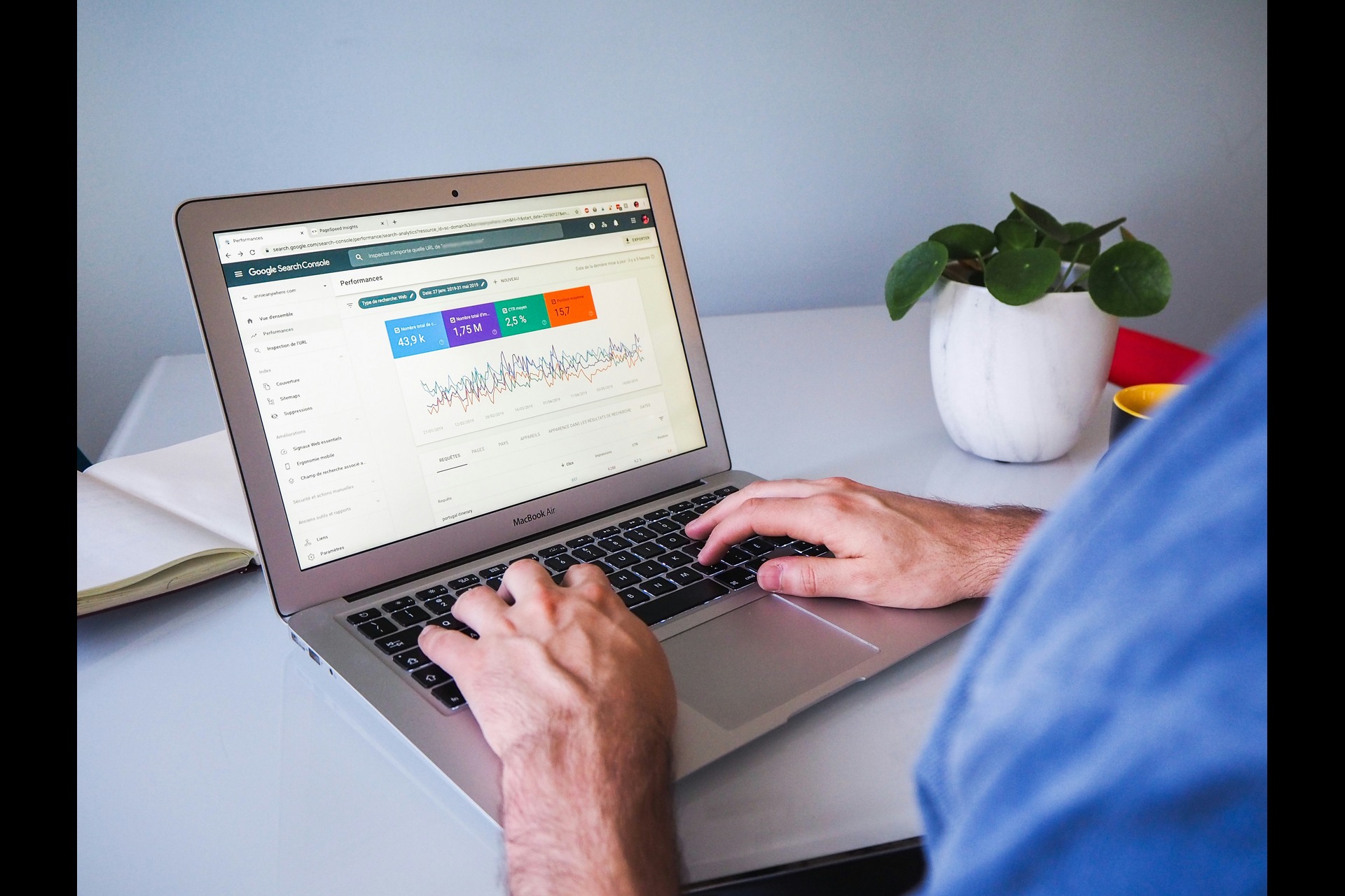 A person using a laptop while looking at Google Search Console