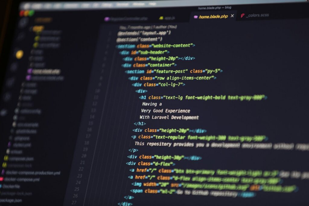 computer monitor dispalying colorful website code in a code editor