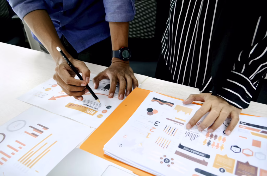 Two people poring over graphs