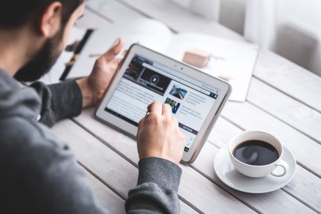 man reading news on tablet