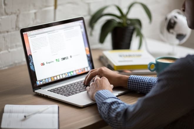 man typing on laptop