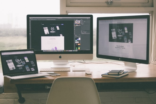 computer monitors and laptop on desk