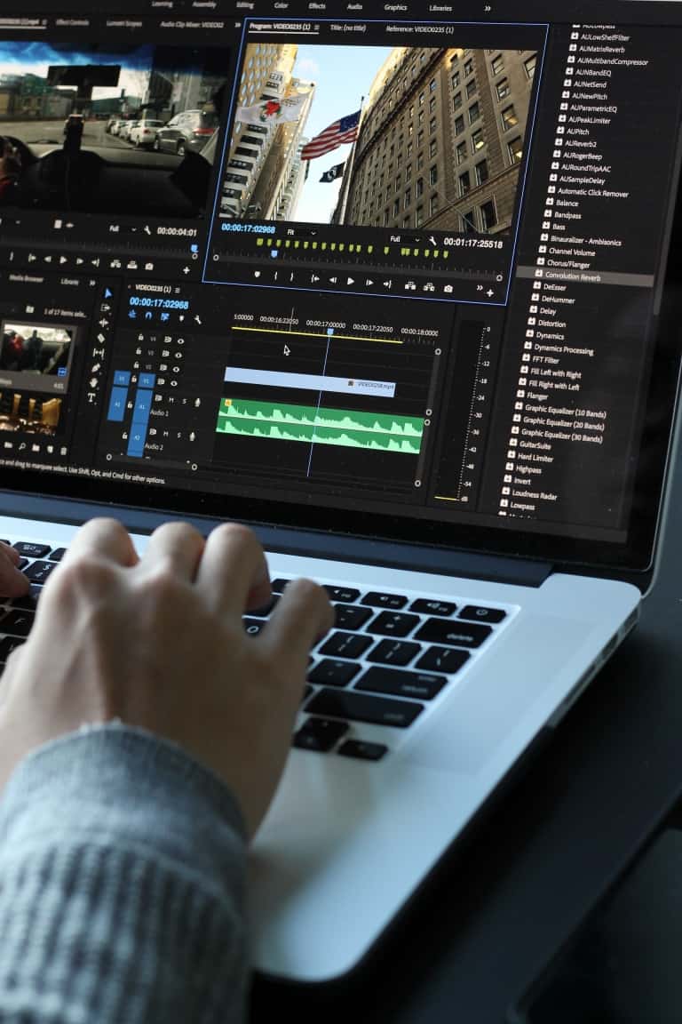 person editing video on laptop