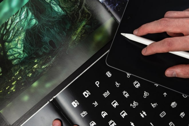 person working on tablet and laptop