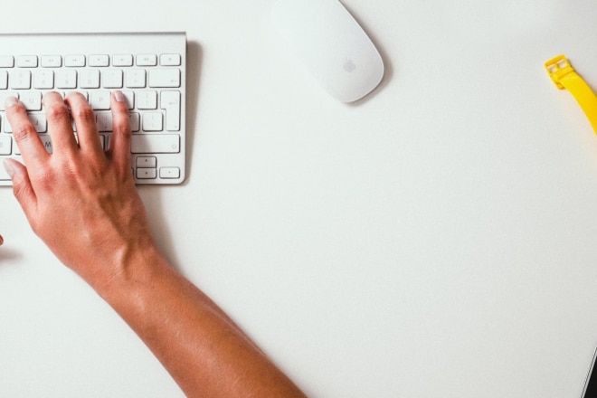 People typing on a computer's keyboard.