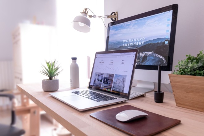 A laptop standing on a desk with an e-commerce website open