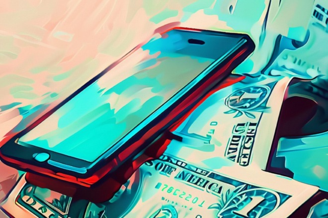 A phone sits in a pile of money