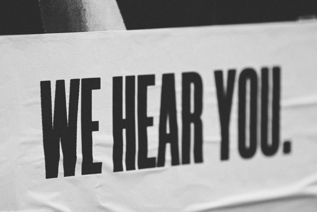 sign saying we hear you