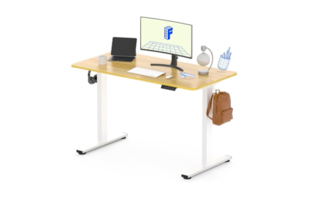 A brown and white 
standing desk with a monitor and keyboard and desk accessories.