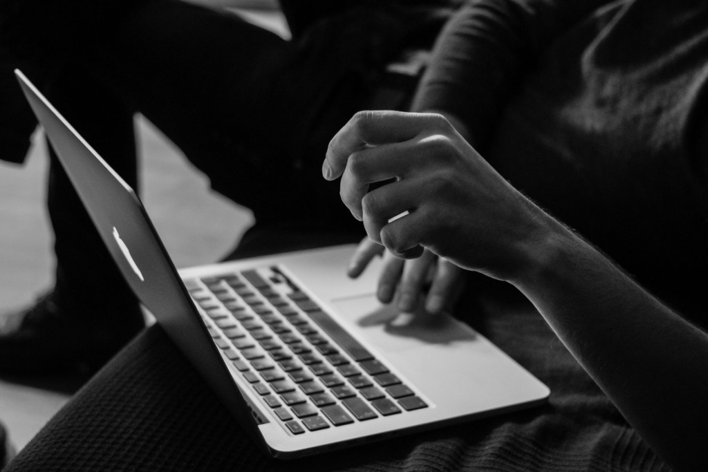 A person sitting with a laptop and working