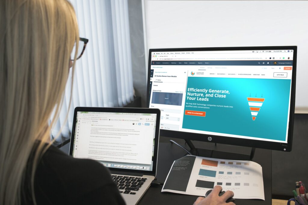 A woman designing a website on a laptop
