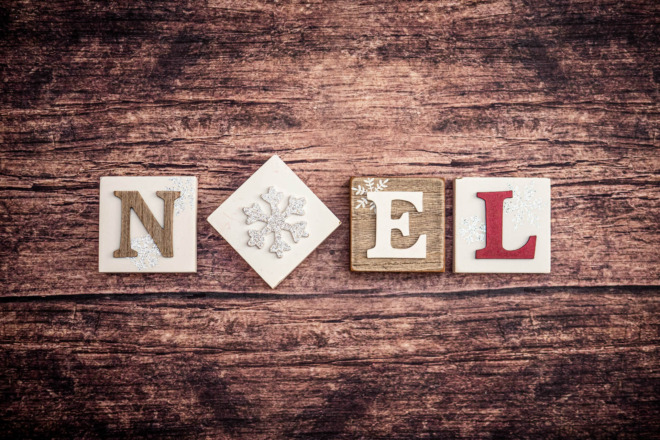 presents on a wood background that say noel