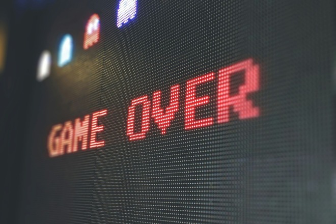 A close-up shot of a retro arcade screen displaying the words 