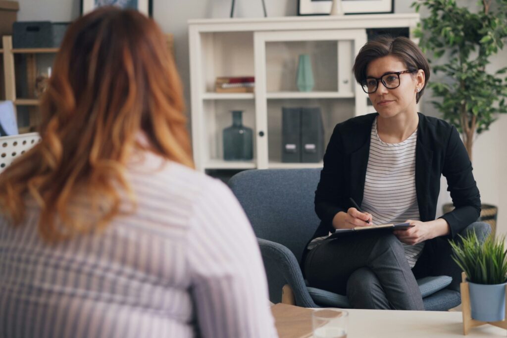 Woman listening and taking notes