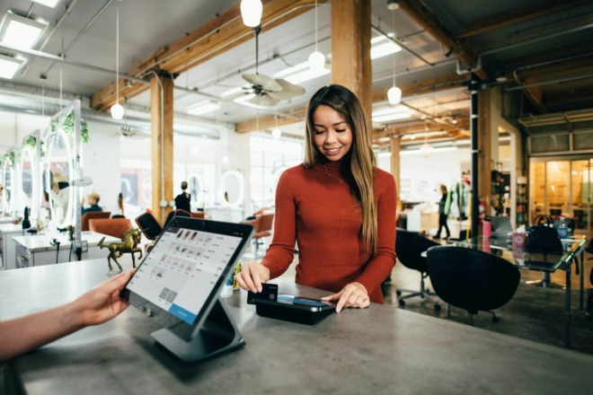 customer swiping their card for payment at a store