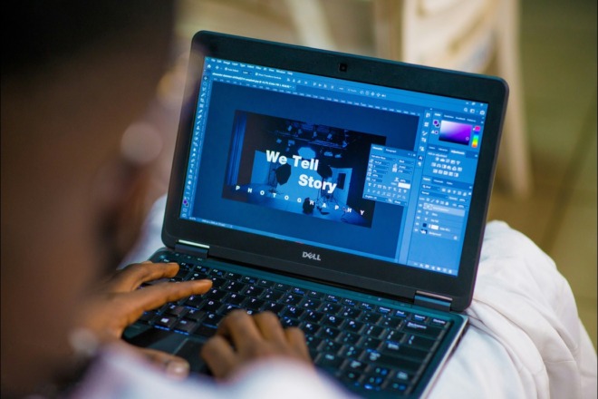 Dark-skinned man designing an visual for a company