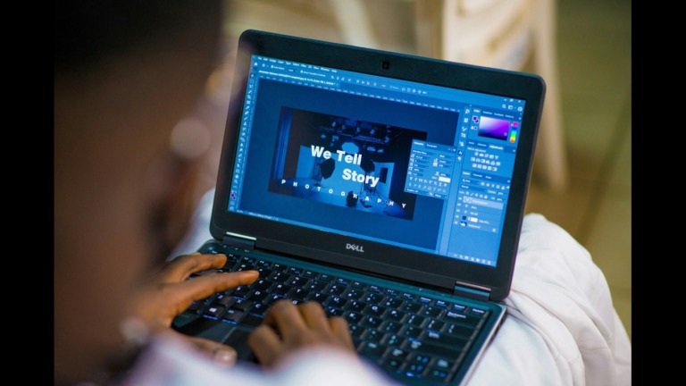 Dark-skinned man designing an visual for a company