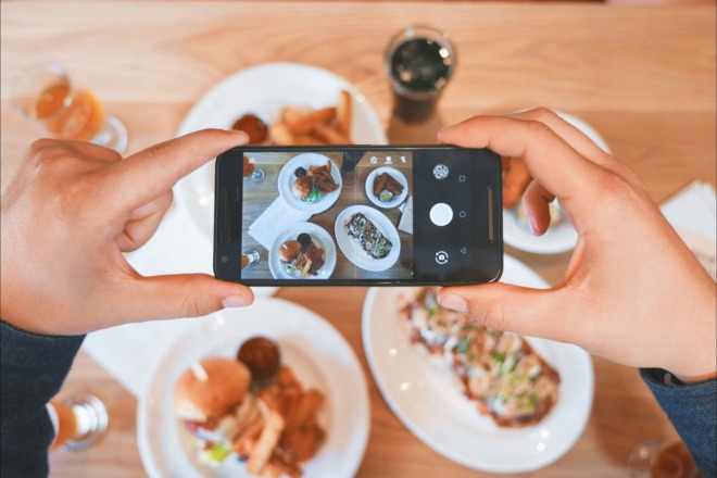 person taking a photo of his food