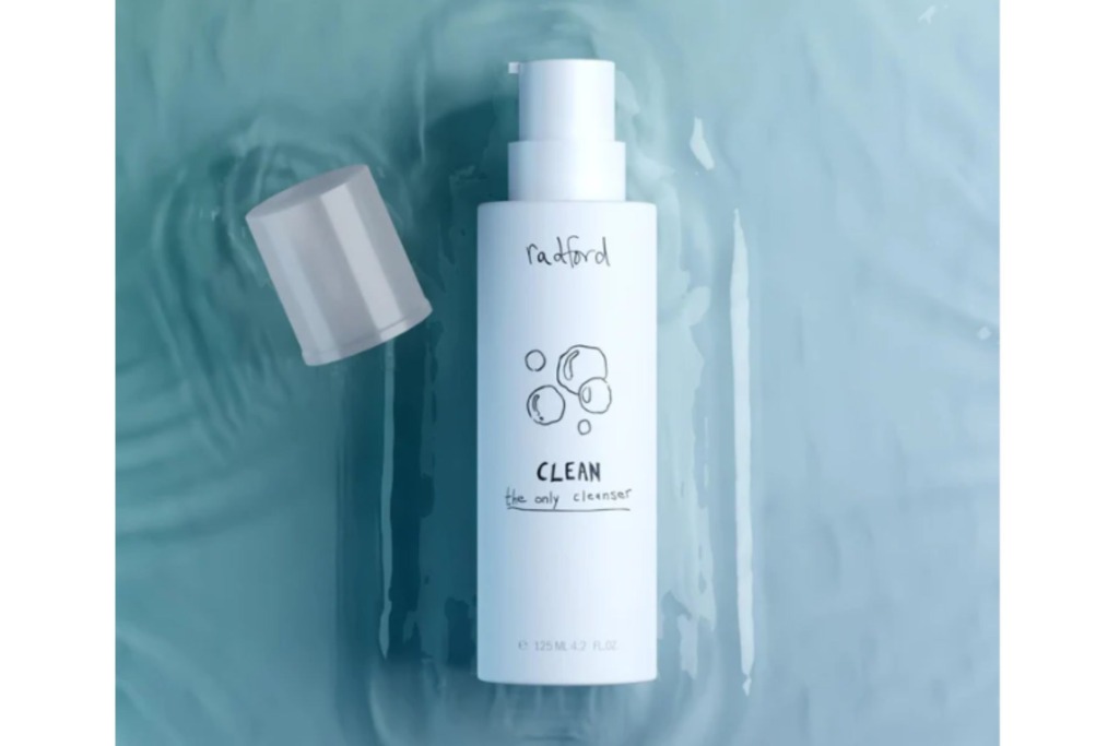 a bottle of Radford Beauty's skincare product floating in clear blue water