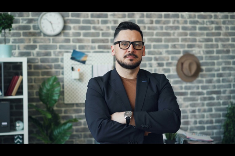 a male supervisor staring into the camera