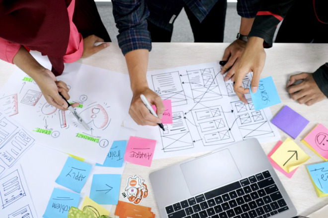 A team of designers create a mockup of a web page.